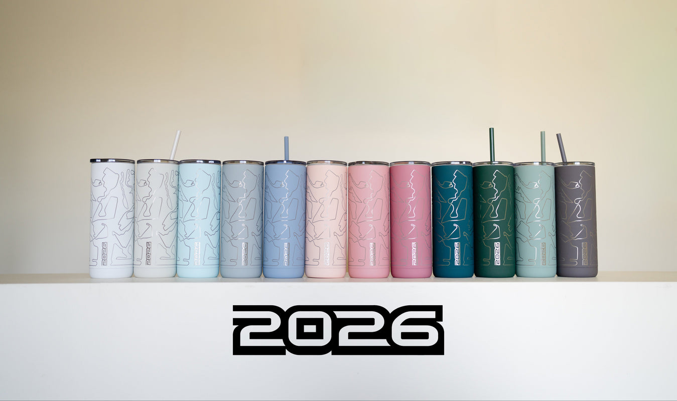Row of colorful tumblers with '2026' logo on a white surface